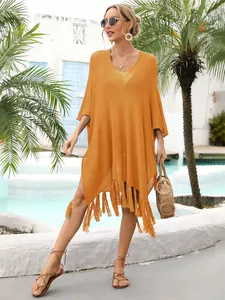 Detail view of mustard yellow crochet beach cover-up with intricate hollow-out patterns