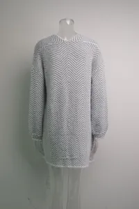 Back view of a grey and white chevron knit mid-length sweater coat on a mannequin