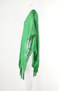 Side view detail of green hollow-out knitted beach cover-up with long tassels.