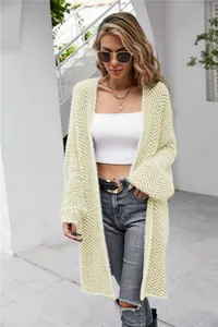 Close-up detail of a long light green chevron knit cardigan with fuzzy textured finish