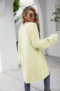 Macro view of light green chevron fuzzy knit cardigan texture and pattern