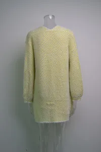 Detailed view of stylish yellow and white chevron knit sweater on a clear mannequin