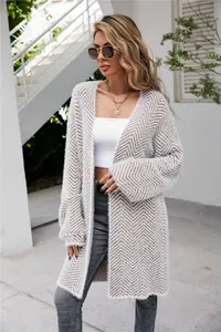 Western street style woman wearing a long chevron knitted cardigan with fuzzy texture.