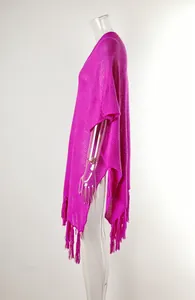 Detailed side view of fuchsia fringed hollow-out knit beach cover-up on mannequin