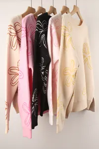Variety of long-sleeved crewneck knit sweaters with floral outline patterns in five colors