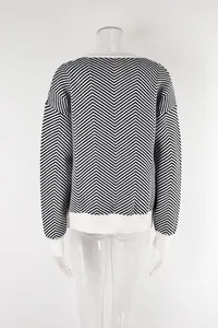 Back view of a black and white chevron pattern knitted cardigan with white ribbed cuffs