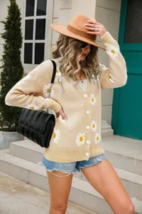 Fashionable beige knit cardigan with white daisy prints shown on a street style model