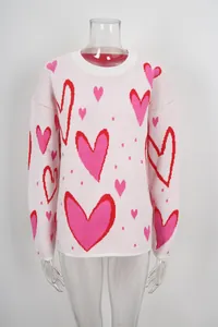 Front view of a pink oversized sweater with red and pink heart patterns on a mannequin