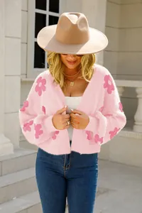 Primer plano de un cárdigan corto rosa peludo con estampado de flores en una modelo