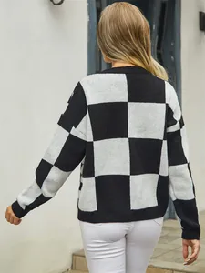 Detailed back view of a women's black and white checkerboard oversized knitted sweater