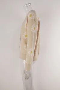 Detailed side view of a beige knitted cardigan featuring white daisy floral prints