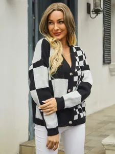 Detailed view of women's black and white checkerboard knit cardigan with V-neckline