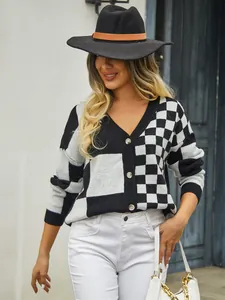 Model wearing a black and white checkerboard patchwork knit cardigan with V-neck