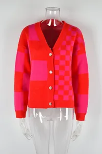 Macro detail of women's red and pink checkered patchwork knit cardigan sweater jacket