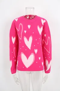 Close-up of pink knit sweater featuring white heart patterns on clear mannequin