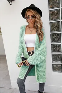 Detail view of stylish light green chevron fuzzy knit cardigan sweater worn by female model