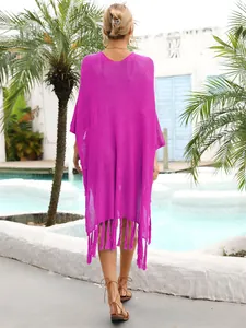 Back view of a purple knit beach cover-up with tassels and hollow out design.