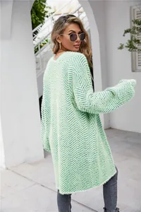 Close-up of women's fuzzy light green zigzag knit cardigan with a soft plush texture