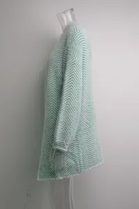 Side view of green and white chevron mohair knit cardigan sweater on mannequin.