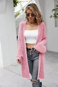 Detailed view of women's long pink fuzzy cardigan with stylish chevron knit pattern