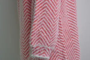 Close-up of pink and white chevron knit fabric with a soft fuzzy texture detail