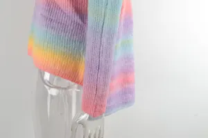Macro view showing the detailed texture and sleeve of a rainbow gradient knit sweater