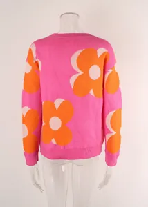 Detailed back view of a pink crew neck sweater with large orange and white flower patterns