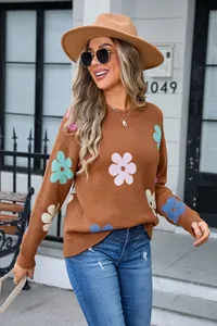 Detail view of brown round neck sweater featuring vibrant colorful floral patterns