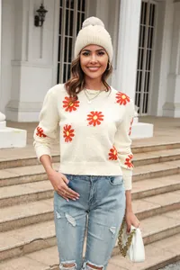 Full length view of a stylish beige daisy pattern round neck knit sweater on a model