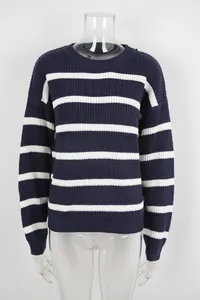Detail of navy blue and white striped knitted sweater with a classic retro loose fit.