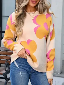 Detail of women's cream knit sweater with large pink and yellow flower patterns