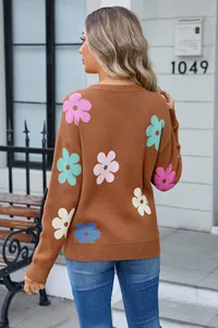 Detailed back view of a cozy brown knit sweater with vibrant colorful flower patterns