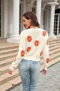 Detailed back view of women's short knitted sweater with red daisy floral patterns