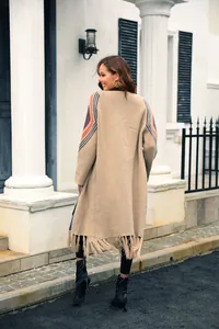 Boho style tan long knit cardigan with fringe hem and colorful striped sleeve details