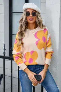 Detail view of stylish women's crewneck knit sweater featuring vibrant oversized floral prints