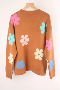 Close-up of a brown knit sweater featuring colorful oversized flower patterns