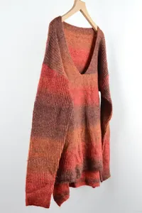 Close-up detail of women's V-neck gradient tie-dye knitted pullover on wooden hanger