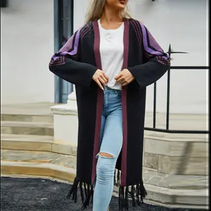 Long black knitted cardigan for women featuring purple sleeve patterns and trendy fringe hem