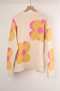 Detailed view of women's crewneck knit sweater with vibrant oversized floral print