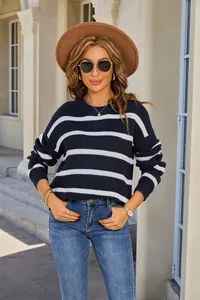 Model wearing a navy and white striped sweater with a vintage loose fit in outdoor light