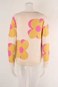 Detail view of the back of a beige knit sweater with large yellow and pink flowers.