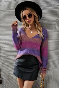 Detail shot of a chic gradient ombre V-neck knit sweater in vibrant purple and pink tones.