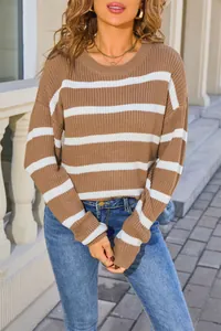 Close-up of brown and white striped knit sweater with thick texture and cozy loose fit