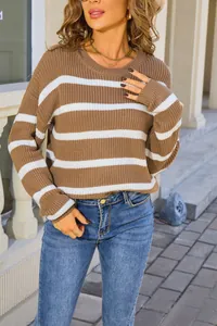 Close-up of retro loose-fit women's striped knit sweater in brown and white colors