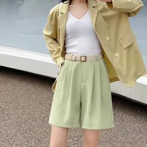 Detailed view of women's high-waisted shorts in light green with a matching belt.