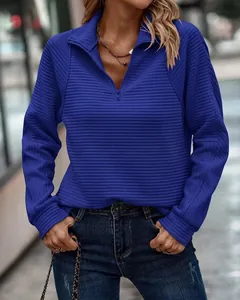 Gedetailleerd overzicht van de textuur van een blauwe dames-sweatshirt met halve rits