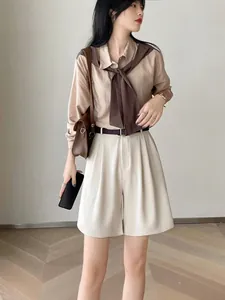 Chic high-waisted beige casual shorts with a matching belt for summer minimalist outfit