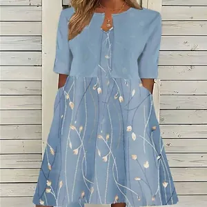 Detail of blue floral long dress with light blue overlay and delicate petal print