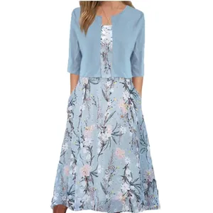 Detail view of elegant light blue floral print maxi dress with matching short cardigan set
