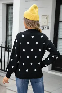 Detailed back view of a cozy black knit sweater featuring white polka dot patterns